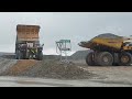 How is a day of work in a mine driving trucks? Dump trucks driving into an open-pit mine