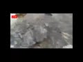 A big stone hits a truck and falls into river during land sliding caused by heavy raining/ flood