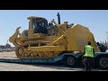 Loading this massive Komatsu 375A Crawler Dozer on the trailer to transport in the site, bull dozer