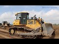 Heavy Shantui Bulldozers Working Plowing Sand & Trago Dump Truck Dumping Sand