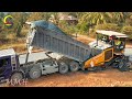 A construction working on a road expansion project. Dump trucks delivering gravel to paving machine