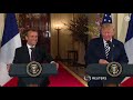 Trump and Macron share an awkward handshake and a kiss