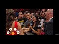 Aaron solo  aew wrestler as wwe  crowd member beside  brie bella