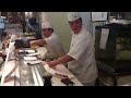 A japanese guy showing off his sushi-making skills