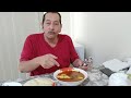 Arab man eating fufu and speaking African language.