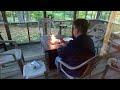 Michael cooking kielbasa over a gas fire pit