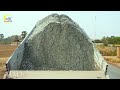 A well-coordinated process of gravel paving and compaction. A single-lane new road construction site