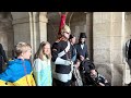 WOMAN IN REAL SHOCK, after the king’s guard YELLS her at the horse GUARDS