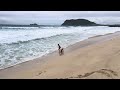 The boys getting knocked over by waves on Pyramid Rock