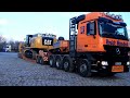 Caterpillar 349E loading brandnew high reach demolition excavator on overzize load transport