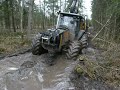 Valtra forestry tractor with big trailer in wet forest