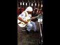 Apostle Kelvin Hall playing guitar at Guitar Center