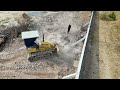 Small Bulldozer Pushing Soil Filling Down The Wall With 5T Dump Trucks