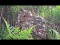 Red bricks 'growing' out of natural rock face? Swansea 'copper quater' see description