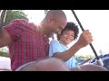 father and son on swing in playground