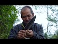jungle man taking & breaking wild small Himalayn bamboo cane