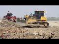 Show Wonderful Stronger Shantui Heavy Bulldozer Pushing Rocks In Water With Dump Truck Unloading