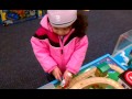 Ari playing with trains in TRU