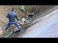 Barge unloading soil with large stones, daily work on the river