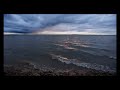 Relaxing waves and Storm Clouds at Sunset