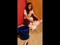 native American girl cleans up spilt bucket pee