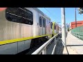 XN40 5963, NABI 45C 8374, and 2 Expo line trains