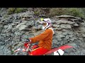 Micha rides down the Black Bear pass steps on a Motorcycle, Honda XR250