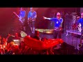 Kid rides giant pizza slice at Aquabats show