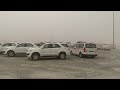 Super strong sand storm hits the yard full of heavy equipment machinery and vehicle. construction