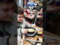 LITTLE CHILD TRIES TO EAT SOUP WITH STICKS