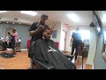 Dario cuts of his dreads after 10 years at Chi Ospina Co. Barber Shop