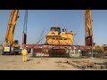 Liebherr LTM 110 ton crane lift the Komatsu 155A dozer on the open container to load on the trailer