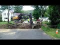 EXCAVATOR DIGING UP TREES FROM THE CREEK