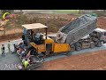 A construction working on a road project, Laying gravel with the paver machine spreading the gravel