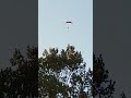 Paraglider flying over the house