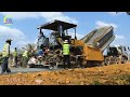 Amazing busy road construction technology with a gravel paver machine, trucks, and road equipment.