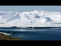 Ilulissat Icefjord - iceberg turning over.