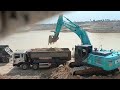 Work activities at the site of excavator kobelco 260lc and dump truck