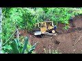 Extreme!! The D6R XL Bulldozer forms a new road by cutting a hillside at the edge of a ravine