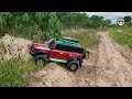 1/10 Scale, Rc Car Off Road Ford Bronco 4×4 driving on the sandy path of a potato field in the woods