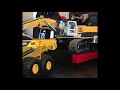 RC excavator with moving driver loading the Bruder Volvo A60H