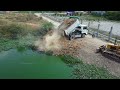 Bulldozer Komatsu D31P Push the soil into the water, Landfill using 5ton truck Unloading Mix VDO