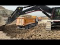 Hidromek Excavator loading two-way truck